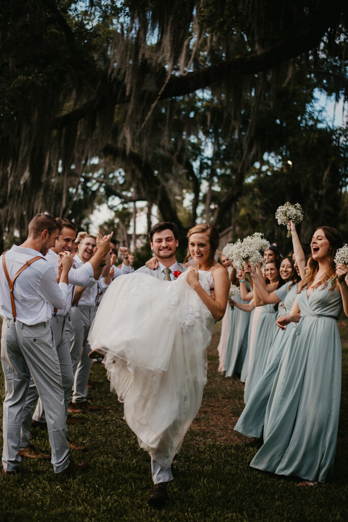 wedding party cheering on bride and groom at saint simons Island