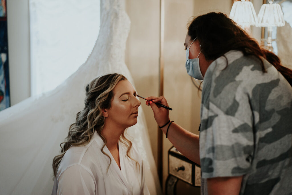MUA doing the bride's eyeshadow