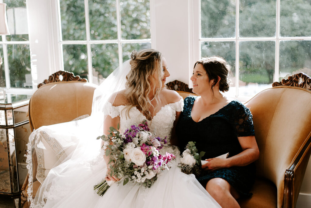 mother and bride sitting in sunroom at Naylor Hall