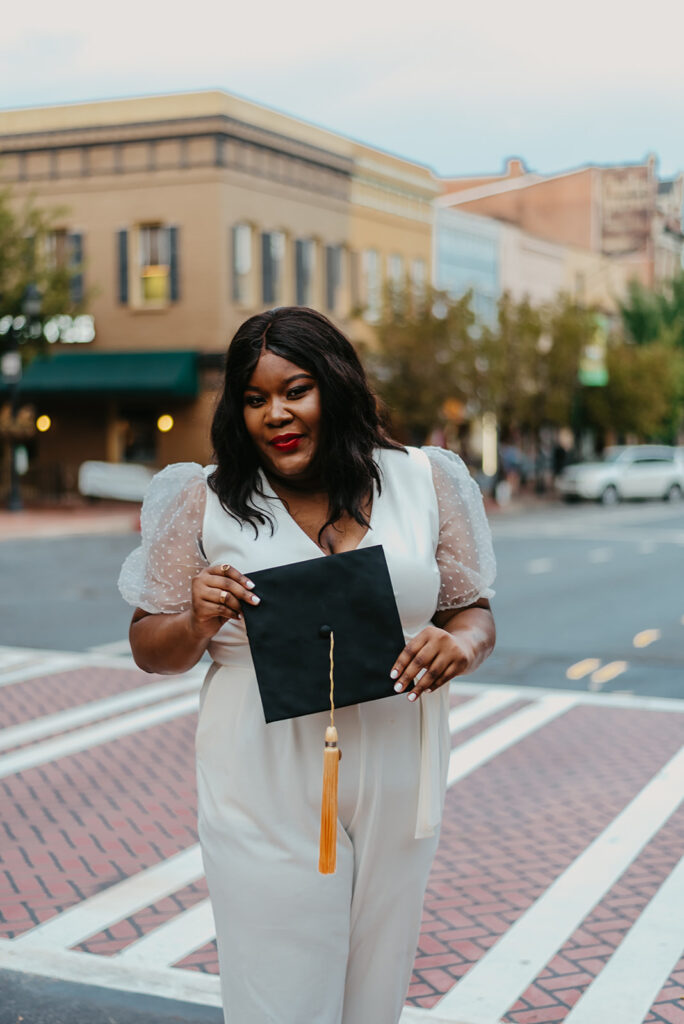 graduate holding cap in downtown Athens GA
