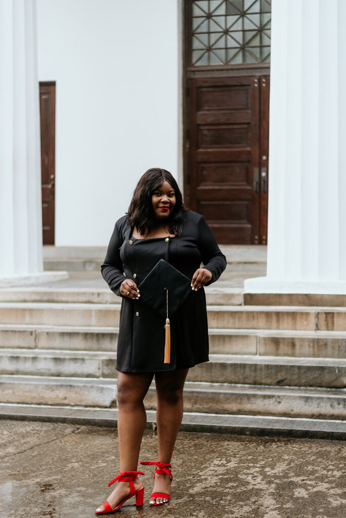 graduate holding cap outside of the chapel building on UGA's campus