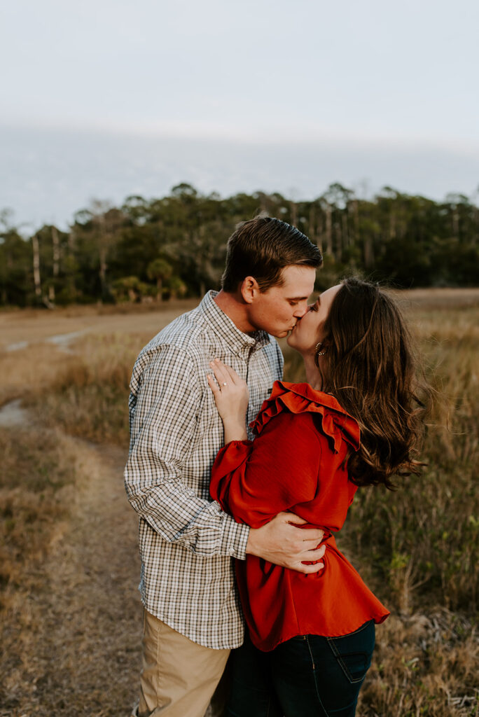 engaged couple kissing at skidaway island