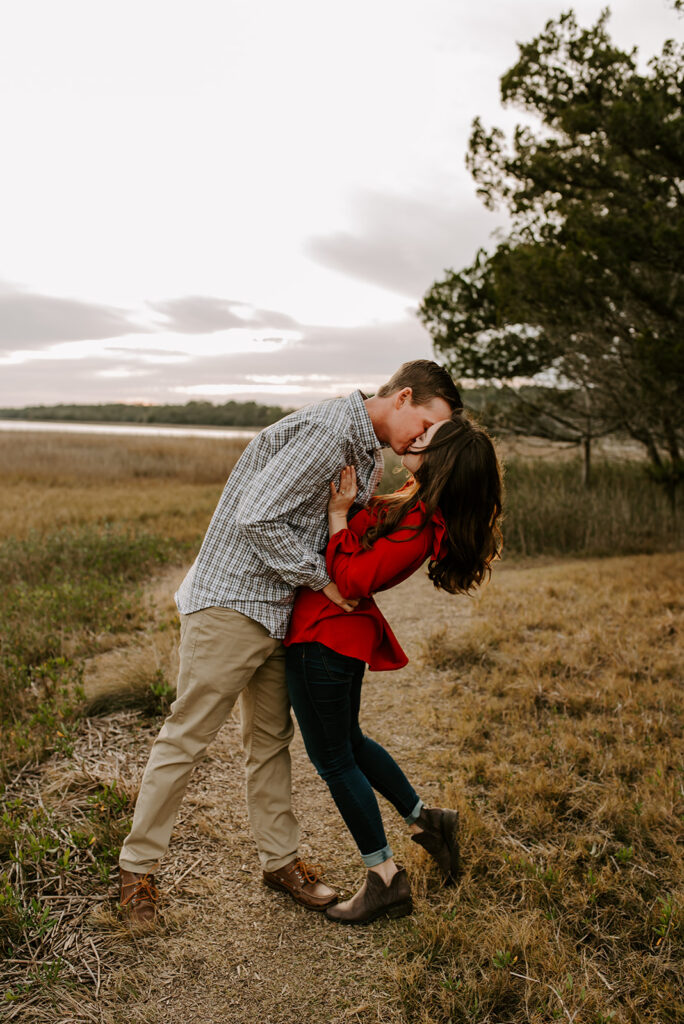engaged couple kissing at skidaway island