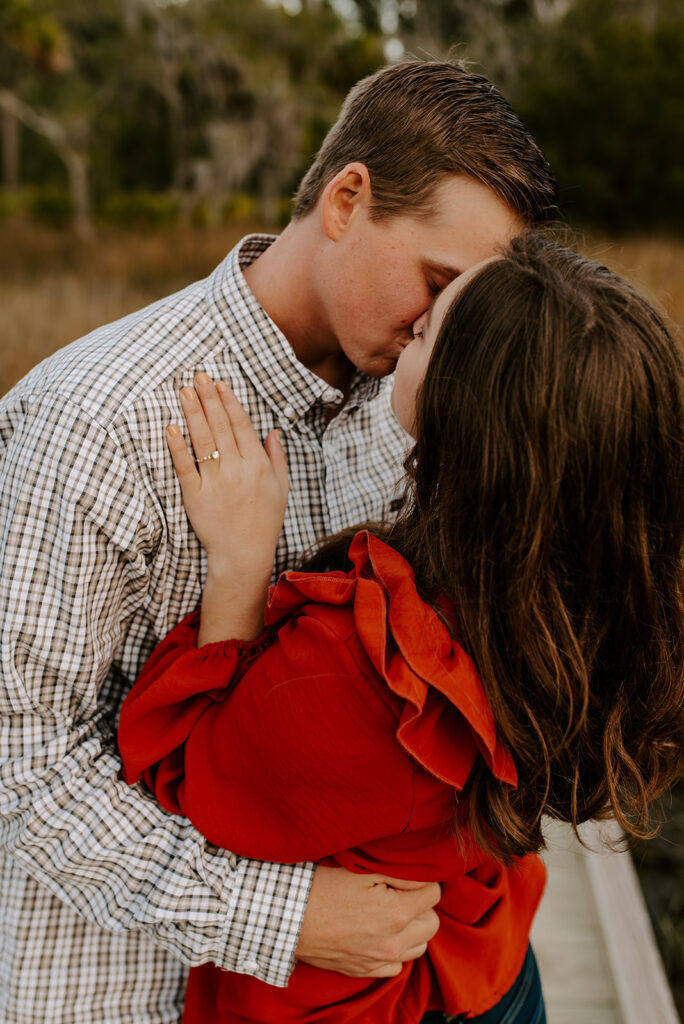 engaged couple kissing at skidaway island engagement session