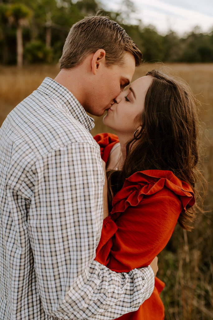 engaged couple kissing at skidaway island engagement session