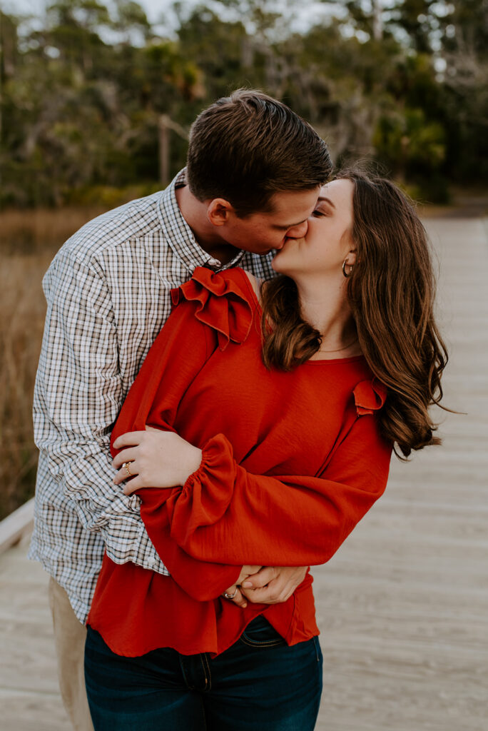 engaged couple kissing at skidaway island engagement session