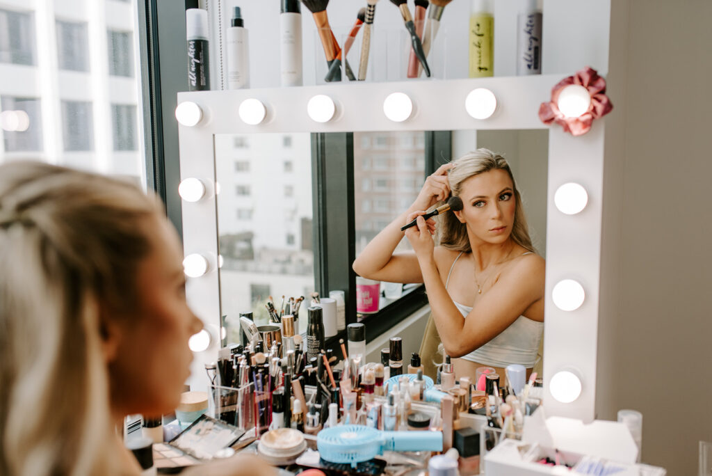 bride doing her makeup in atlanta midtown apartment