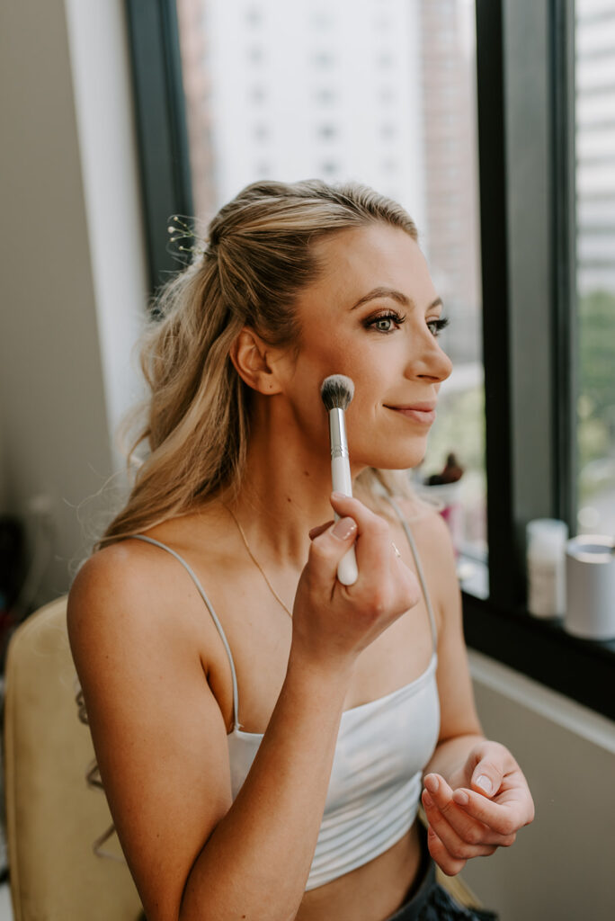 bride doing her makeup in atlanta midtown apartment