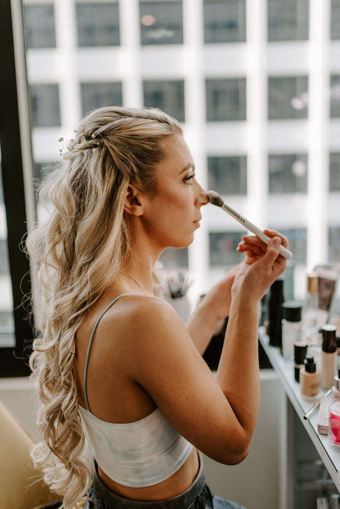bride doing her makeup in atlanta midtown apartment