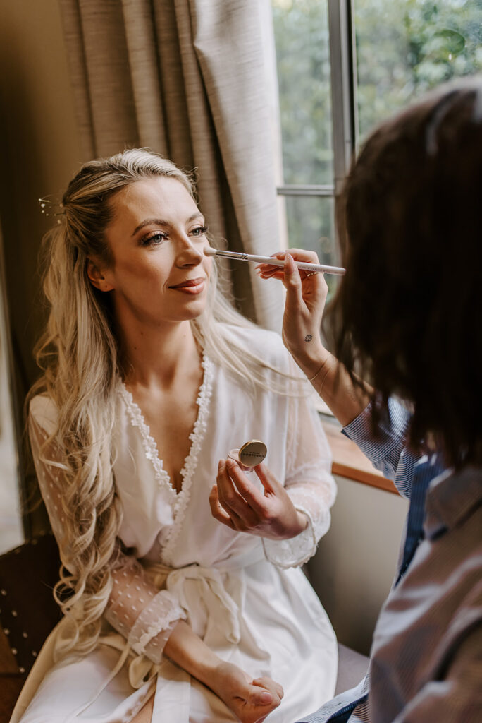 bride doing her makeup in atlanta midtown apartment