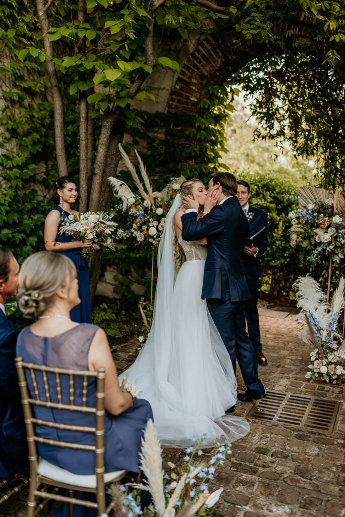 bride and groom's first kiss at summerour studio in atlanta georgia