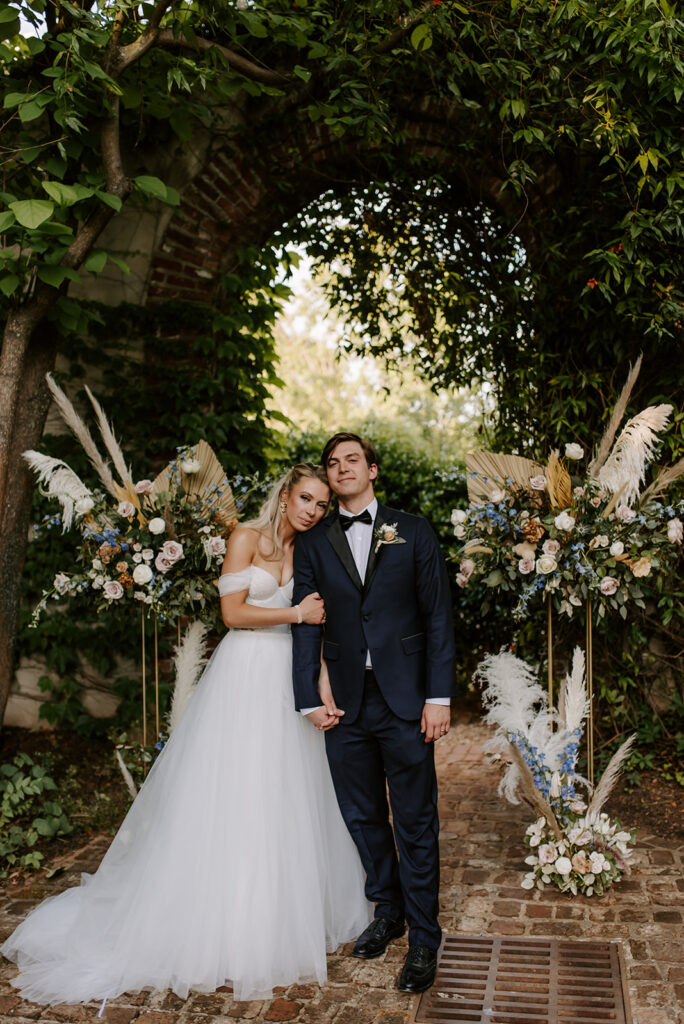 bride and groom wearing a blue suit posing at summerour studio