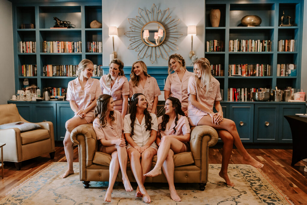 bridesmaids on couch laughing at the reserve club