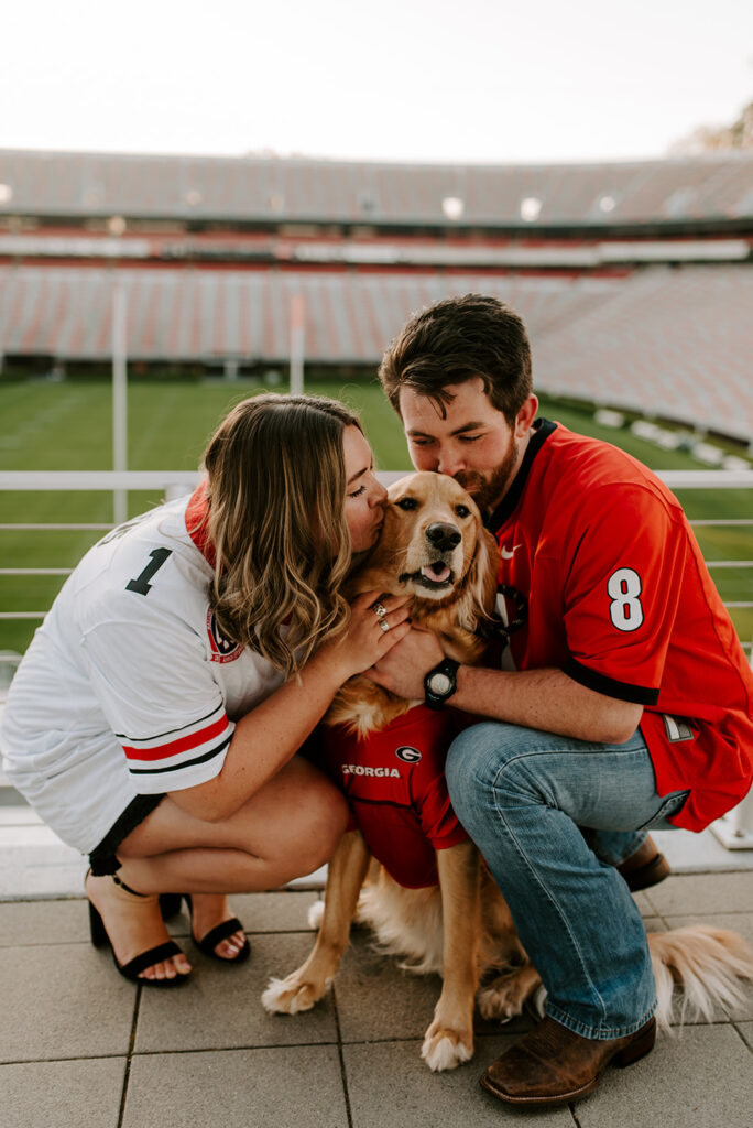 couple kissing dog at UGA