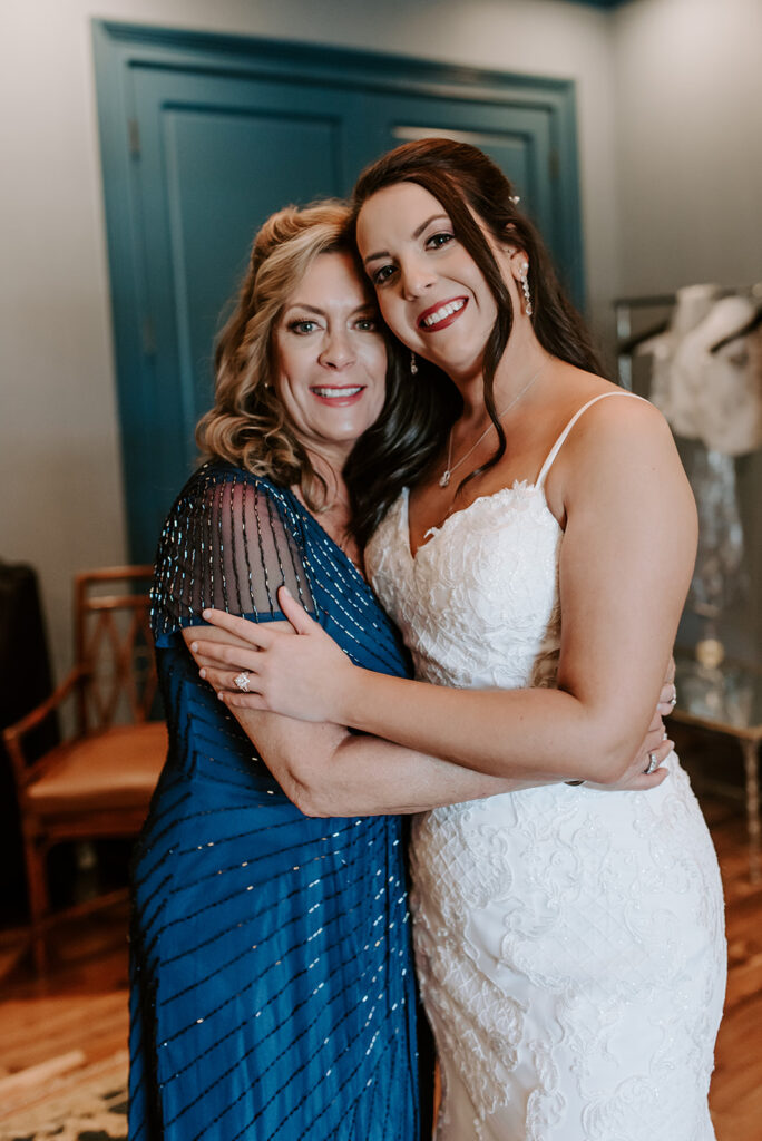 mom and bride hugging on wedding day