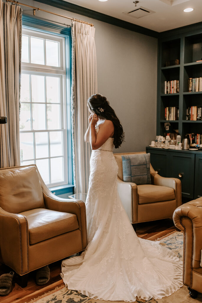 bride putting on earrings at the reserve club