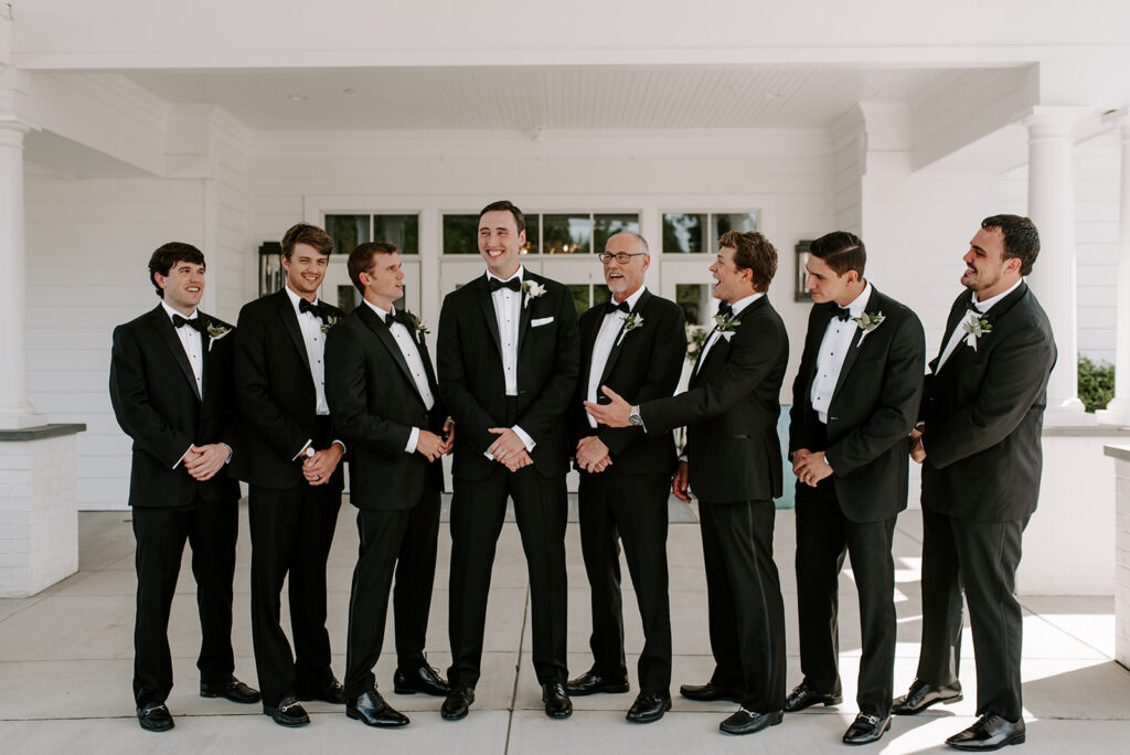 groomsmen laughing with groom at the reserve club in aiken south carolina