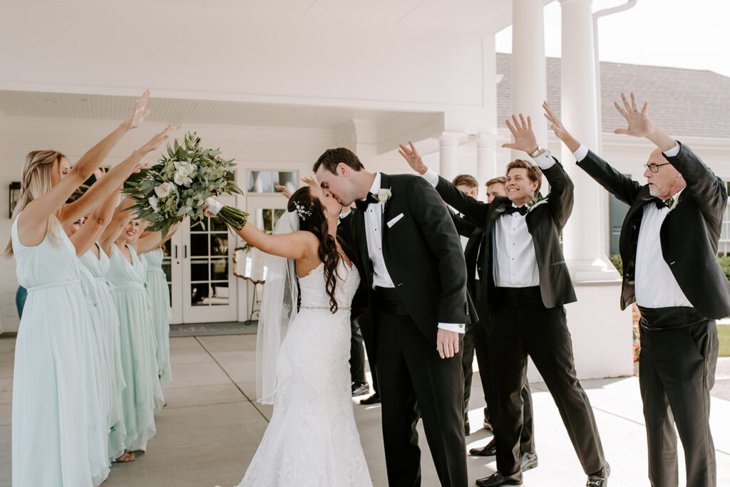 bridal party cheering for the bride and groom at the reserve club