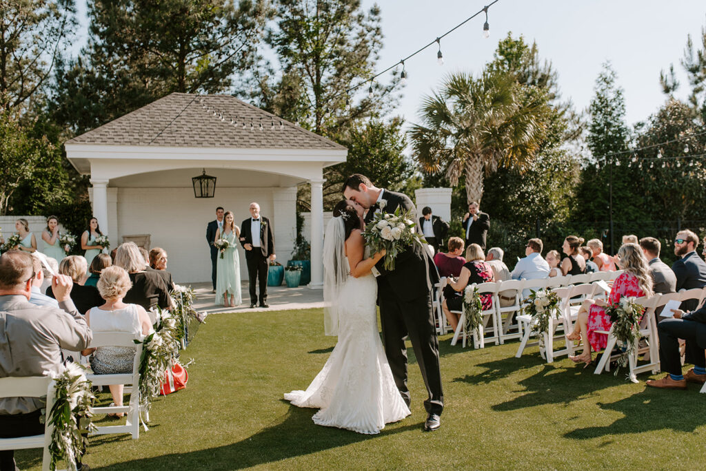 bride and groom sharing their first kiss at the reserve club in aiken south carolina