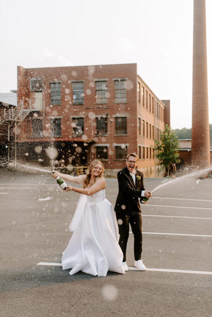factory at walton mill bride and groom popping champagne
