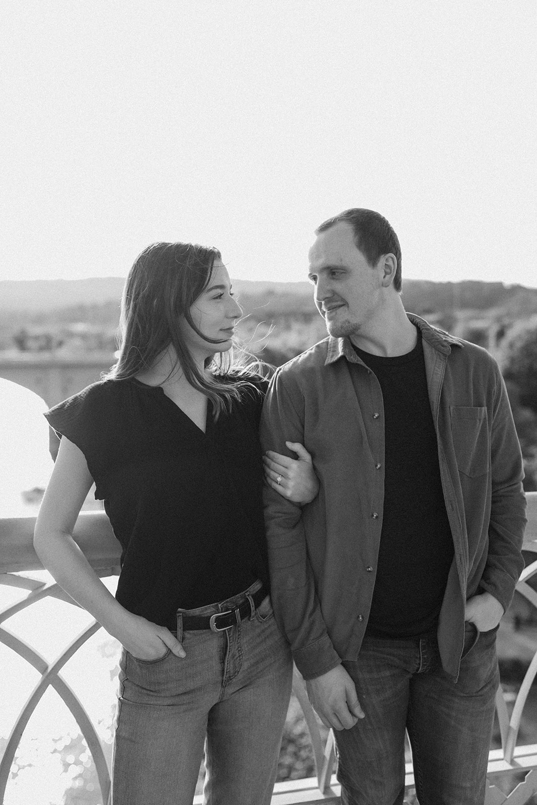 couple smiling at each other by walnut street bridge