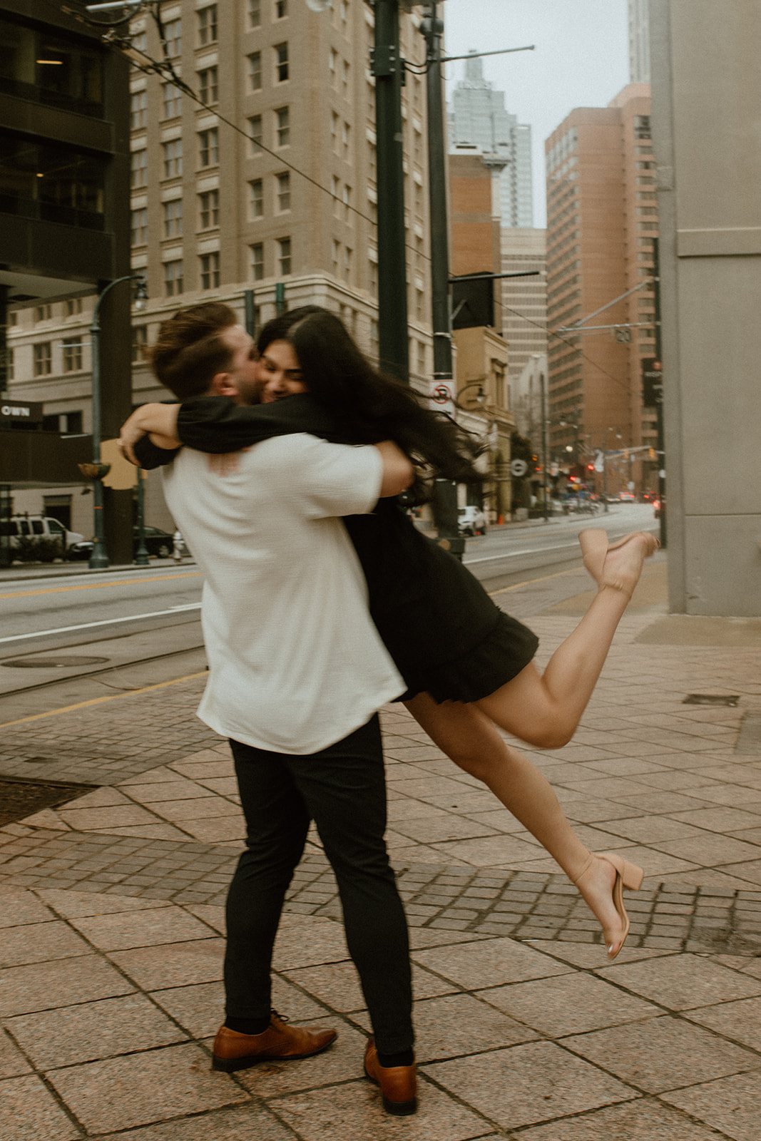 guy spinning girlfriend in downtown atlanta